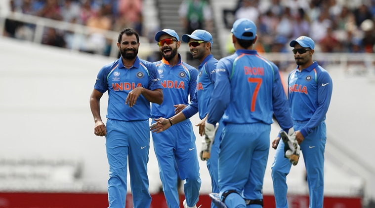 India’s Mohammad Shami (L) celebrates the wicket of New Zealand’s Neil Broom
